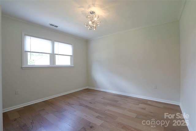 8829 Gelligum Dr, Charlotte, NC 28277 - spare room with crown molding, wood finished floors, and a chandelier