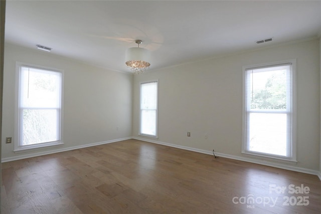8829 Gelligum Dr, Charlotte, NC 28277 - unfurnished room with healthy amount of natural light, wood finished floors, and crown molding