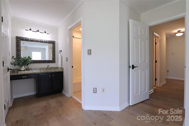 8829 Gelligum Dr, Charlotte, NC 28277 - full bath with wood finished floors, vanity, and crown molding