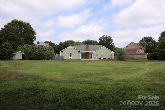 8829 Gelligum Dr, Charlotte, NC 28277 - view of front of home featuring a storage shed, a front yard, and a chimney