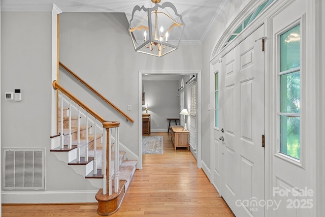 2358 Sparrow Dr, Rock Hill, SC 29732 - entryway featuring ornamental molding, stairway, light wood finished floors, and a chandelier