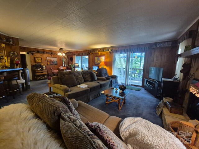 217 Shortoff Ln, Highlands, NC 28741 - living room featuring wood walls, carpet, and ceiling fan
