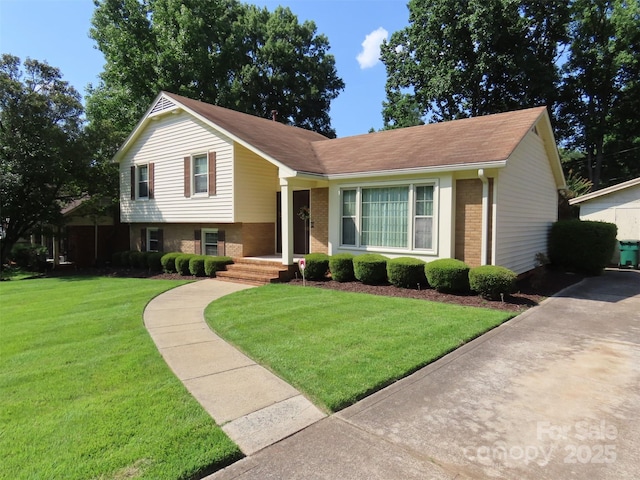 5823 Rupert Ln, Charlotte, NC 28215 - split level home featuring brick siding, a front lawn, and a shingled roof
