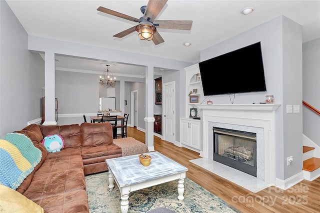 2044 Gable Way Ln, Matthews, NC 28104 - living room with ceiling fan, a chandelier, a premium fireplace, light wood-style floors, and recessed lighting