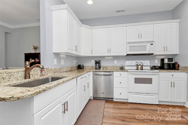 2044 Gable Way Ln, Matthews, NC 28104 - kitchen featuring white appliances, light wood finished floors, white cabinets, light stone counters, and crown molding