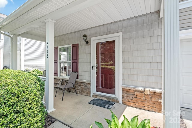 8618 Redding Glen Ave, Charlotte, NC 28216 - doorway to property featuring a porch and stone siding