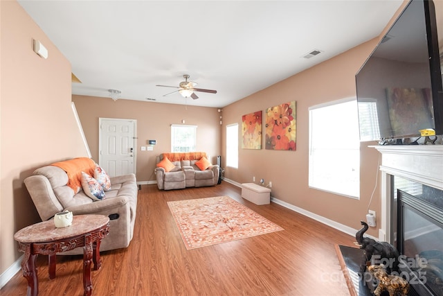 8618 Redding Glen Ave, Charlotte, NC 28216 - living area featuring a ceiling fan, wood finished floors, and a glass covered fireplace