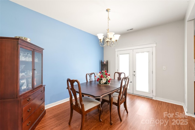 8618 Redding Glen Ave, Charlotte, NC 28216 - dining room featuring a chandelier, light wood finished floors, and french doors