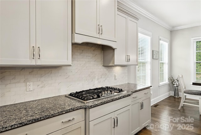 221 N Centurion Ln, Mount Holly, NC 28120 - kitchen featuring stainless steel gas cooktop, crown molding, dark wood finished floors, dark stone countertops, and decorative backsplash