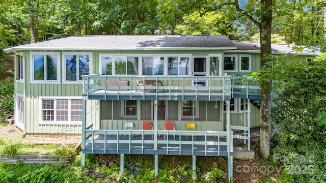 203 Laurel Ln, Little Switzerland, NC 28752 - view of front of property with a sunroom, a shingled roof, board and batten siding, and a wooden deck