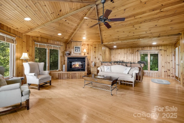203 Laurel Ln, Little Switzerland, NC 28752 - living area with wood ceiling, wood walls, light wood-type flooring, lofted ceiling, and a multi sided fireplace