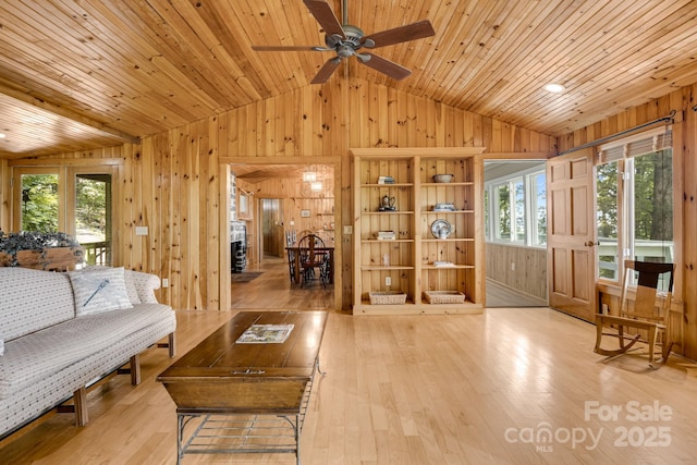203 Laurel Ln, Little Switzerland, NC 28752 - living area with lofted ceiling, wood walls, hardwood / wood-style flooring, ceiling fan, and wood ceiling