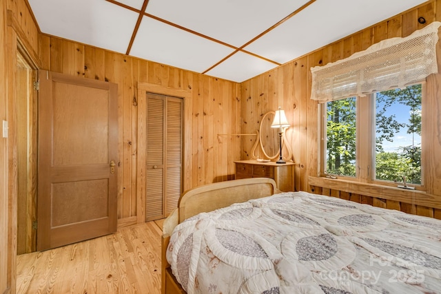 203 Laurel Ln, Little Switzerland, NC 28752 - bedroom with wooden walls, a closet, and wood finished floors
