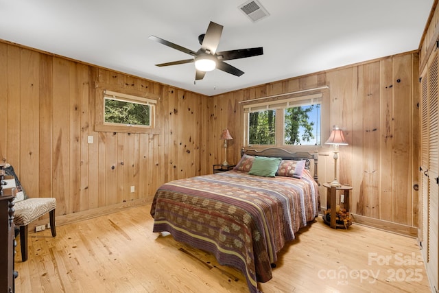 203 Laurel Ln, Little Switzerland, NC 28752 - bedroom with wood walls, wood finished floors, and ceiling fan