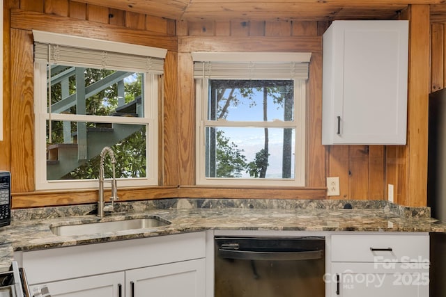 203 Laurel Ln, Little Switzerland, NC 28752 - kitchen featuring dishwasher, white cabinets, stone countertops, plenty of natural light, and wooden walls