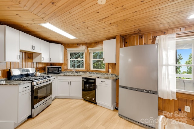 203 Laurel Ln, Little Switzerland, NC 28752 - kitchen featuring wood ceiling, black appliances, light stone counters, healthy amount of natural light, and white cabinetry