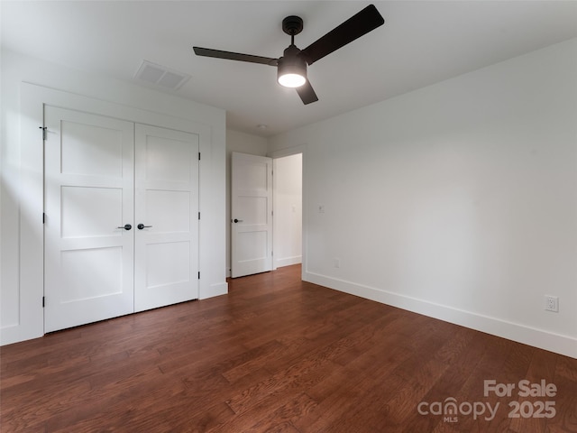 285 Poplar Crest Dr, Pisgah Forest, NC 28768 - unfurnished bedroom featuring dark wood-style flooring, a closet, and ceiling fan