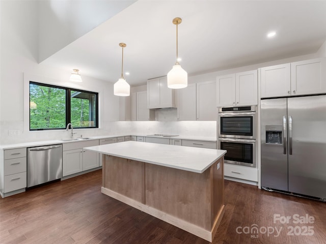 285 Poplar Crest Dr, Pisgah Forest, NC 28768 - kitchen with appliances with stainless steel finishes, light countertops, dark wood finished floors, decorative backsplash, and recessed lighting