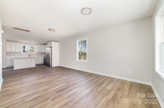 2206 Hillcrest Ave, Albemarle, NC 28001 - unfurnished living room featuring wood finished floors and baseboards