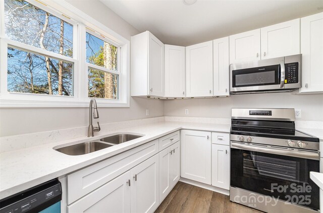 2206 Hillcrest Ave, Albemarle, NC 28001 - kitchen with appliances with stainless steel finishes, white cabinetry, and dark wood-style flooring