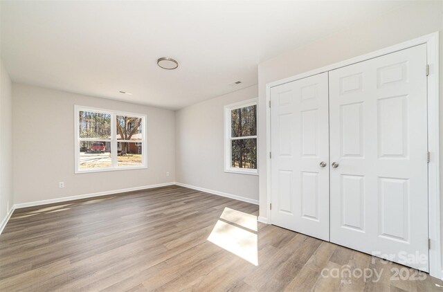 2206 Hillcrest Ave, Albemarle, NC 28001 - unfurnished bedroom with wood finished floors and a closet