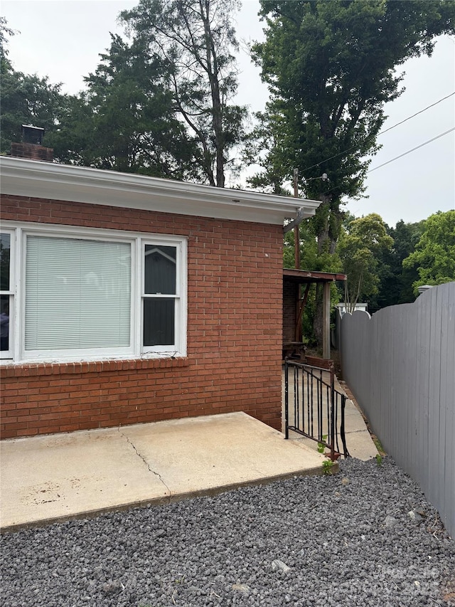 3166 Poplar Tent Rd, Concord, NC 28027 - view of side of property featuring brick siding, a patio, and a chimney