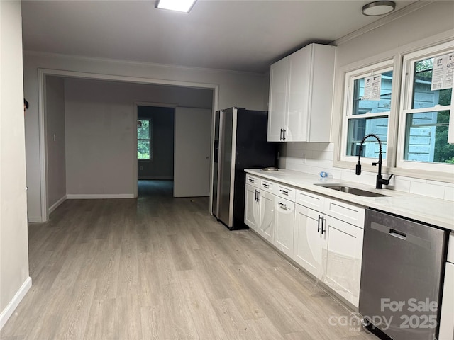 3166 Poplar Tent Rd, Concord, NC 28027 - kitchen featuring appliances with stainless steel finishes, light wood-style flooring, light countertops, white cabinets, and ornamental molding