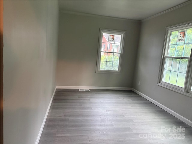 3166 Poplar Tent Rd, Concord, NC 28027 - empty room featuring crown molding, healthy amount of natural light, and wood finished floors