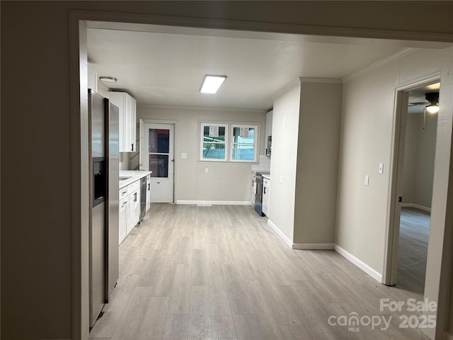 3166 Poplar Tent Rd, Concord, NC 28027 - kitchen featuring crown molding, white cabinets, light wood-style floors, light countertops, and stainless steel appliances