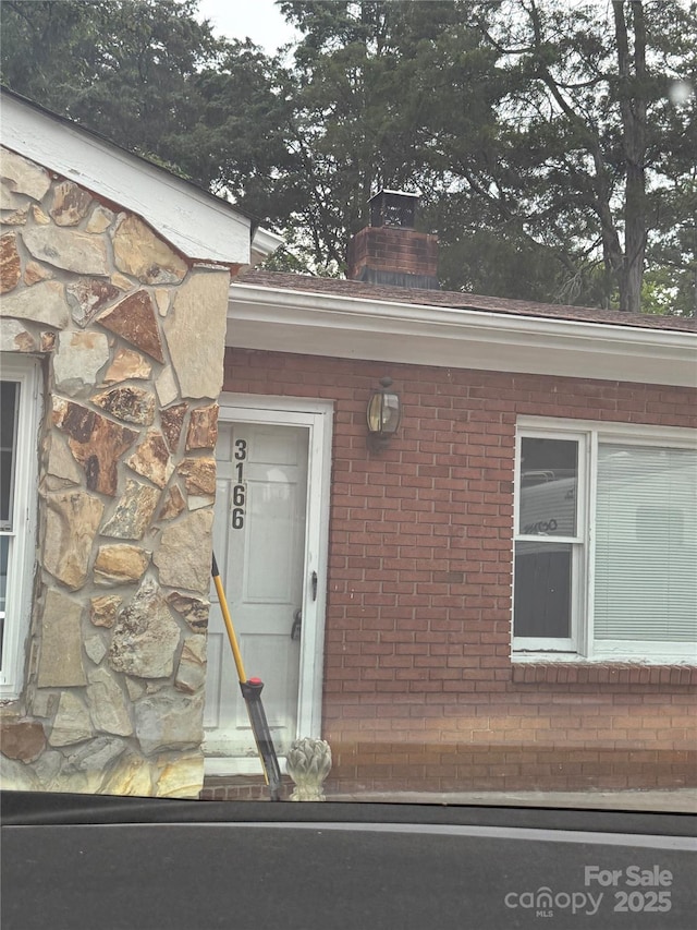 3166 Poplar Tent Rd, Concord, NC 28027 - doorway to property with a chimney, stone siding, and brick siding