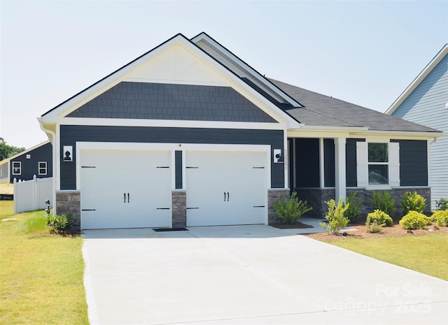 12209 Riceland Way, Midland, NC 28107 - craftsman-style house with stone siding, a garage, driveway, and a front yard