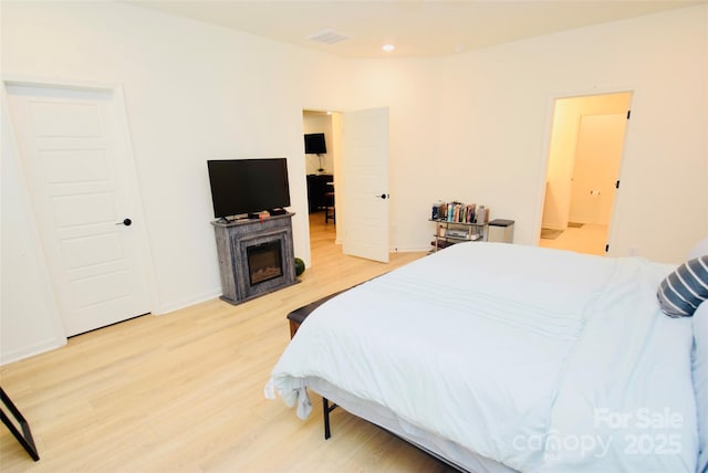 12209 Riceland Way, Midland, NC 28107 - bedroom featuring light wood-style floors, a fireplace, and recessed lighting