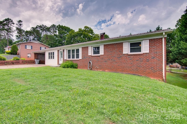 2310 Honeysuckle Pl, Lenoir, NC 28645 - ranch-style home with a chimney, driveway, brick siding, and a patio area
