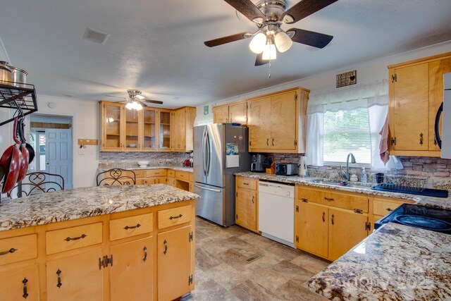 2310 Honeysuckle Pl, Lenoir, NC 28645 - kitchen featuring appliances with stainless steel finishes, ceiling fan, tasteful backsplash, and glass insert cabinets