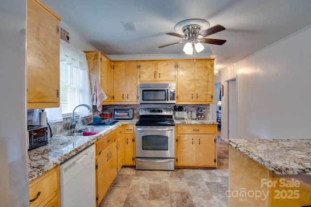 2310 Honeysuckle Pl, Lenoir, NC 28645 - kitchen featuring appliances with stainless steel finishes, tasteful backsplash, ceiling fan, stone finish floors, and light stone counters
