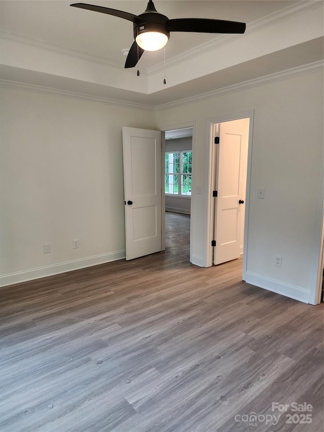723 Taylor St, Rock Hill, SC 29730 - unfurnished bedroom featuring crown molding, wood finished floors, a tray ceiling, and a ceiling fan