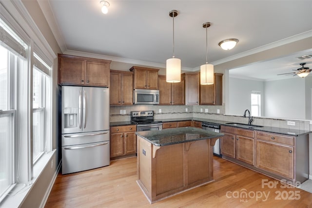 365 Battery Cir, Clover, SC 29710 - kitchen with appliances with stainless steel finishes, brown cabinetry, a peninsula, decorative backsplash, and crown molding