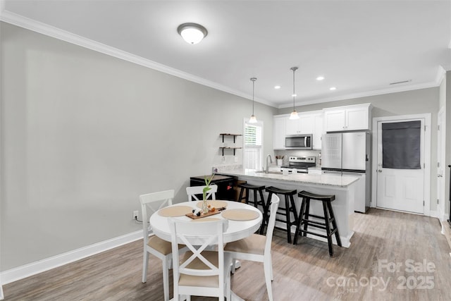2662 14th St NE, Hickory, NC 28601 - dining room with light wood-style floors, ornamental molding, and recessed lighting