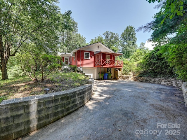 123 Blake Dr, Arden, NC 28704 - view of front of property featuring asphalt driveway, a garage, and a deck