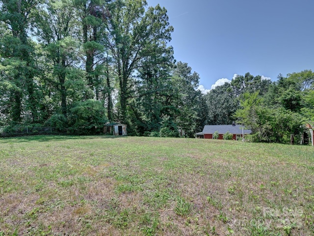 123 Blake Dr, Arden, NC 28704 - view of grassy yard featuring a storage shed and a view of trees
