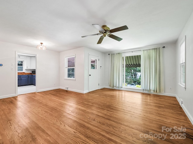 123 Blake Dr, Arden, NC 28704 - unfurnished living room featuring plenty of natural light, ceiling fan, and light wood-style floors