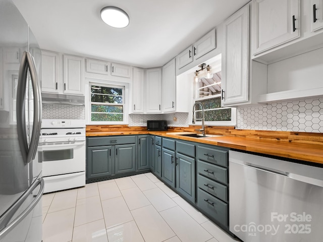 123 Blake Dr, Arden, NC 28704 - kitchen with stainless steel appliances, wood counters, decorative backsplash, and white cabinets