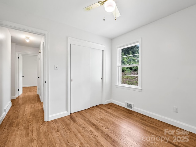123 Blake Dr, Arden, NC 28704 - unfurnished bedroom featuring light wood-style floors, a closet, and a ceiling fan