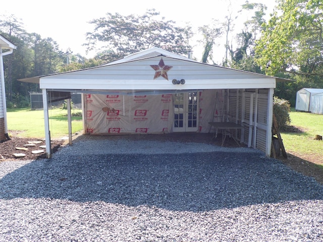 1475 Ferguson Dr, Clemmons, NC 27012 - garage featuring a storage shed, french doors, a carport, and driveway