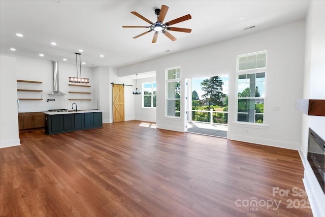 108 Augusta Ln, Shelby, NC 28150 - unfurnished living room featuring a barn door, recessed lighting, ceiling fan, and dark wood-type flooring