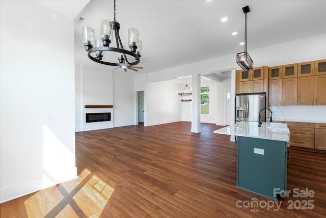 108 Augusta Ln, Shelby, NC 28150 - kitchen with stainless steel fridge with ice dispenser, a chandelier, light countertops, dark wood-style floors, and decorative light fixtures