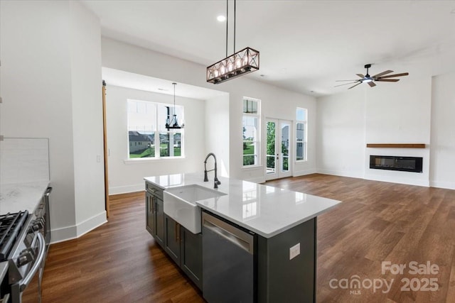 108 Augusta Ln, Shelby, NC 28150 - kitchen featuring stainless steel appliances, dark wood finished floors, pendant lighting, a glass covered fireplace, and a chandelier