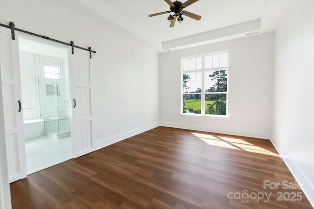 108 Augusta Ln, Shelby, NC 28150 - unfurnished room featuring plenty of natural light, a barn door, dark wood-style flooring, and ceiling fan