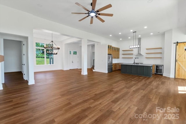 108 Augusta Ln, Shelby, NC 28150 - unfurnished living room featuring wine cooler, a barn door, recessed lighting, dark wood-style floors, and a ceiling fan