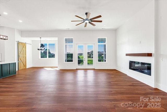 108 Augusta Ln, Shelby, NC 28150 - unfurnished living room featuring a barn door, a glass covered fireplace, dark wood-style flooring, recessed lighting, and ceiling fan